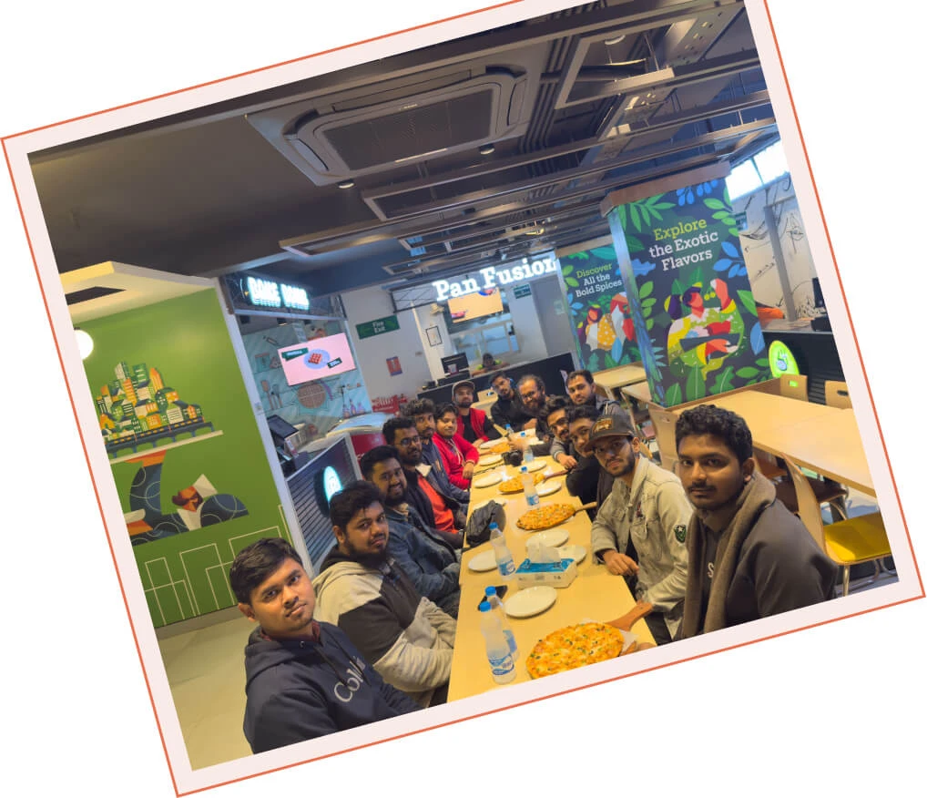 The Panze team gathered along a long table on a pizza outing