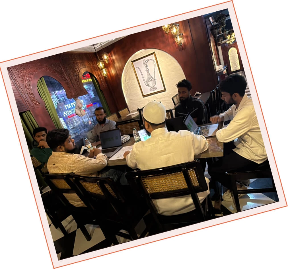 The Panze team in a working session around a restaurant table with laptops